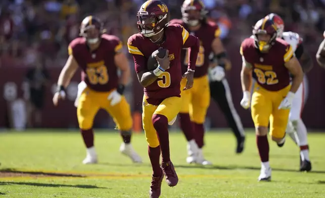 Washington Commanders quarterback Jayden Daniels (5) runs for a long gain against the Cleveland Browns during the second half of an NFL football game in Landover, Md., Sunday, Oct. 6, 2024. (AP Photo/Stephanie Scarbrough)