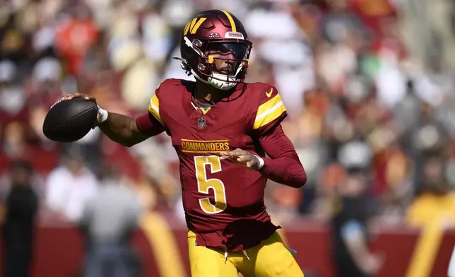 Washington Commanders quarterback Jayden Daniels (5) looks to pass against the Cleveland Browns during the first half of an NFL football game in Landover, Md., Sunday, Oct. 6, 2024. (AP Photo/Nick Wass)