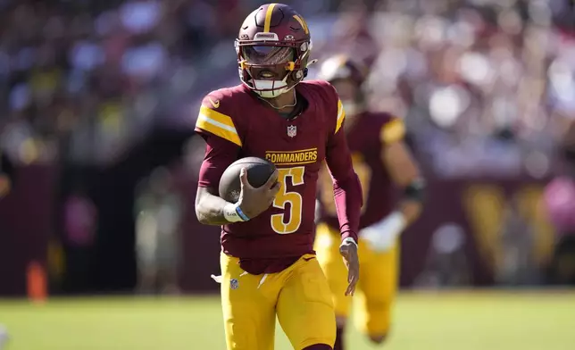 Washington Commanders quarterback Jayden Daniels (5) runs for a long gain against the Cleveland Browns during the second half of an NFL football game in Landover, Md., Sunday, Oct. 6, 2024. (AP Photo/Stephanie Scarbrough)