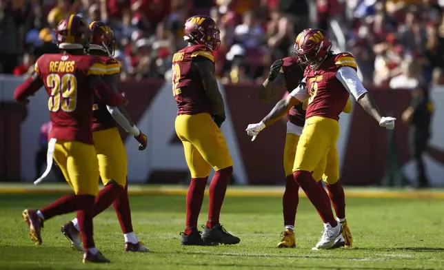 Washington Commanders linebacker Dante Fowler Jr., right, celebrates his sack of Cleveland Browns quarterback Deshaun Watson (not shown) during the second half of an NFL football game in Landover, Md., Sunday, Oct. 6, 2024. (AP Photo/Nick Wass)