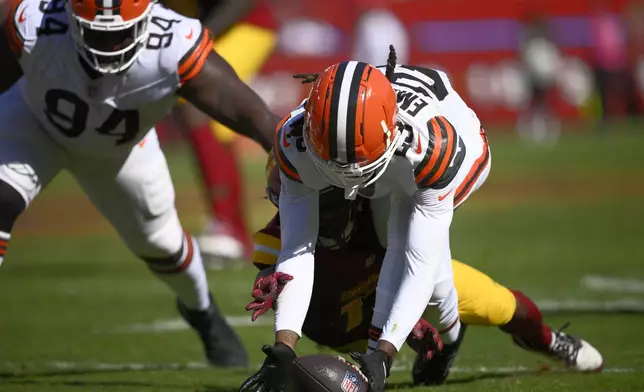 Cleveland Browns cornerback Martin Emerson Jr. (23) recovers a fumble against the Washington Commanders during the second half of an NFL football game in Landover, Md., Sunday, Oct. 6, 2024. (AP Photo/Nick Wass)