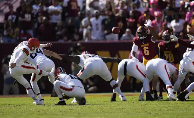 Cleveland Browns place kicker Dustin Hopkins, left, kicks a filed goal against the Washington Commanders during the second half of an NFL football game in Landover, Md., Sunday, Oct. 6, 2024. (AP Photo/Stephanie Scarbrough)