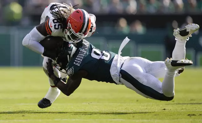 Philadelphia Eagles safety C.J. Gardner-Johnson (8) stops Cleveland Browns tight end David Njoku (85) during the second half of an NFL football game Sunday, Oct. 13, 2024, in Philadelphia. (AP Photo/Matt Rourke)