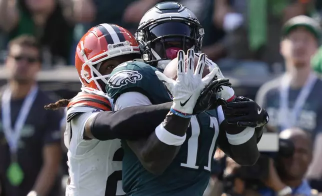 Philadelphia Eagles wide receiver A.J. Brown (11) scores a touchdown in front of Cleveland Browns cornerback Martin Emerson Jr. (23) during the first half of an NFL football game Sunday, Oct. 13, 2024, in Philadelphia. (AP Photo/Matt Rourke)