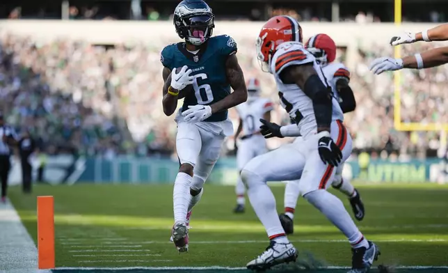 Philadelphia Eagles wide receiver DeVonta Smith (6) runs with the ball for a touchdown during the second half of an NFL football game against the Cleveland Browns on Sunday, Oct. 13, 2024, in Philadelphia. (AP Photo/Matt Slocum)