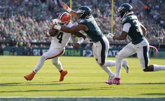 Philadelphia Eagles linebacker Nolan Smith Jr. (3) brings down Cleveland Browns quarterback Deshaun Watson (4) during the second half of an NFL football game Sunday, Oct. 13, 2024, in Philadelphia. (AP Photo/Matt Rourke)