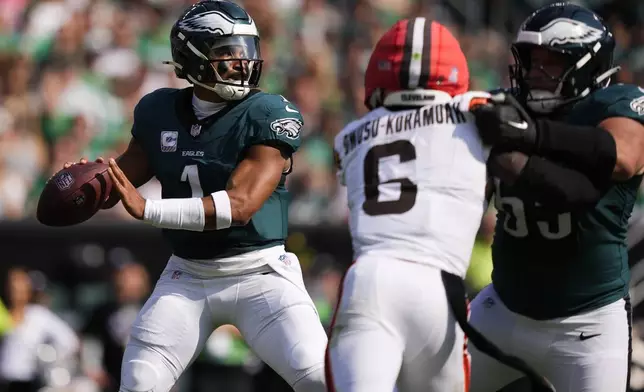 Philadelphia Eagles quarterback Jalen Hurts (1) looks to pass during the first half of an NFL football game against the Cleveland Browns on Sunday, Oct. 13, 2024, in Philadelphia. (AP Photo/Matt Slocum)