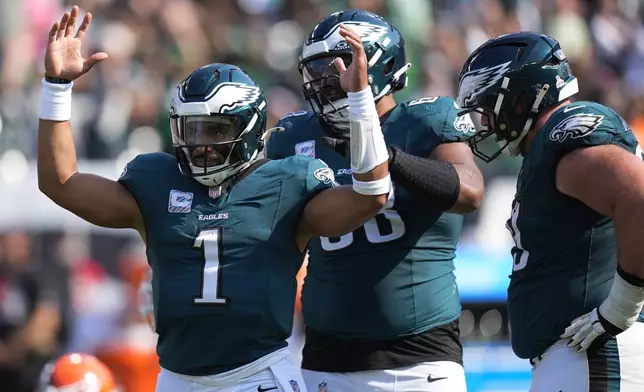 Philadelphia Eagles quarterback Jalen Hurts (1) celebrates throwing to Philadelphia Eagles wide receiver A.J. Brown for a touchdown during the first half of an NFL football game against the Cleveland Browns on Sunday, Oct. 13, 2024, in Philadelphia. (AP Photo/Chris Szagola)