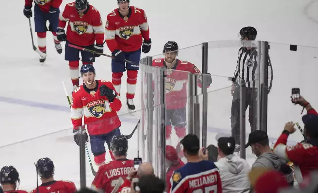 Florida Panthers center Sam Bennett (9) heads to the bench to celebrate a goal against the Boston Bruins during the first period of an NHL hockey game, Tuesday, Oct. 8, 2024, in Sunrise, Fla. (AP Photo/Jim Rassol)