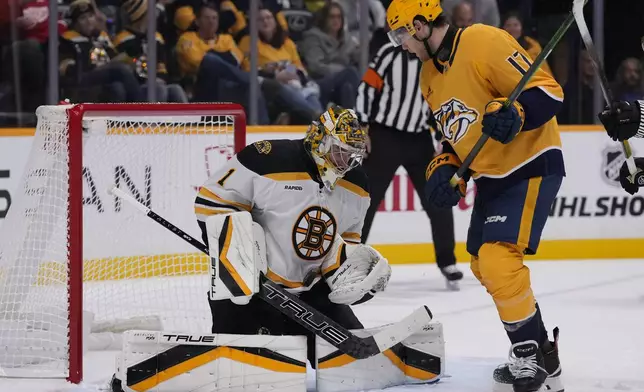 Boston Bruins goaltender Jeremy Swayman (1) defends the goal against Nashville Predators center Mark Jankowski (17) during the second period of an NHL hockey game Tuesday, Oct. 22, 2024, in Nashville, Tenn. (AP Photo/George Walker IV)