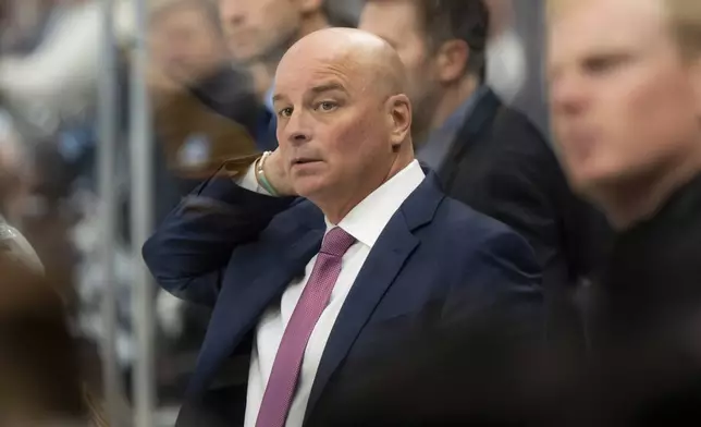 Boston Bruins head coach Jim Montgomery watches the action during the second period of an NHL hockey game against the Utah Hockey Club, Saturday, Oct. 19, 2024, in Salt Lake City. (AP Photo/Spenser Heaps)