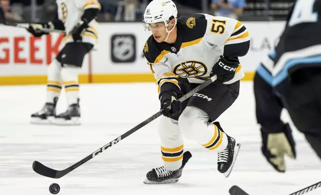 Boston Bruins center Matthew Poitras moves the puck up the ice during the first period of an NHL hockey game against the Utah Hockey Club, Saturday, Oct. 19, 2024, in Salt Lake City. (AP Photo/Spenser Heaps)