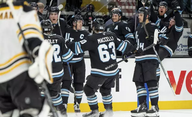 Utah Hockey Club celebrates a winning goal in overtime in an NHL hockey game against the Boston Bruins, Saturday, Oct. 19, 2024, in Salt Lake City. (AP Photo/Spenser Heaps)