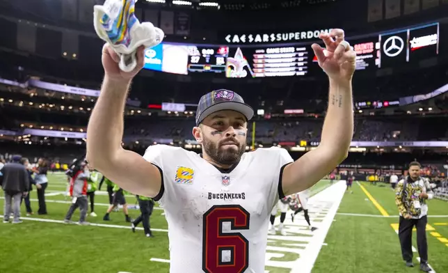 Tampa Bay Buccaneers quarterback Baker Mayfield (6) celebrates as he leaves the field following an NFL football game against New Orleans Saints in New Orleans, Sunday, Oct. 13, 2024. (AP Photo/Michael Conroy)