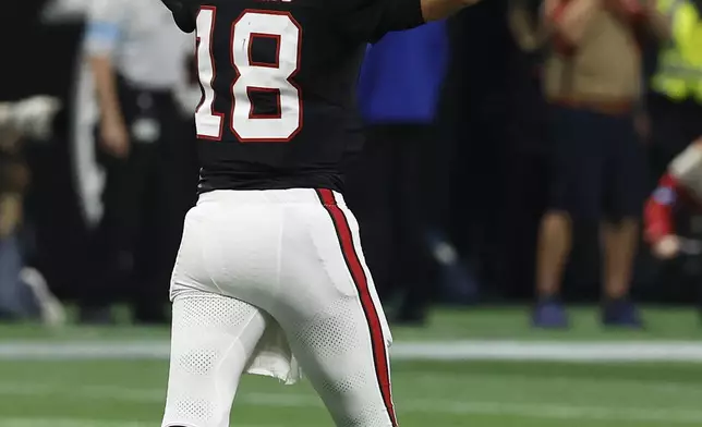 Atlanta Falcons quarterback Kirk Cousins (18) celebrates after throwing a game-wining touchdown pass to wide receiver KhaDarel Hodge against the Tampa Bay Buccaneers during overtime in an NFL football game Thursday, Oct. 3, 2024, in Atlanta. (AP Photo/Butch Dill)