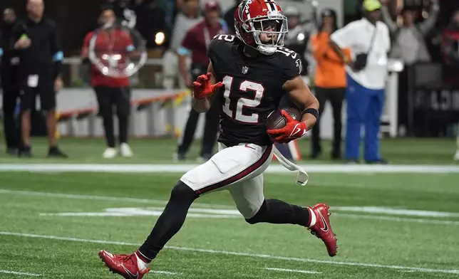 Atlanta Falcons wide receiver KhaDarel Hodge (12) scores the game-wining touchdown against the Tampa Bay Buccaneers during overtime in an NFL football game Thursday, Oct. 3, 2024, in Atlanta. (AP Photo/John Bazemore)