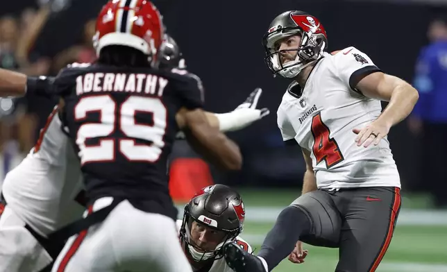 Tampa Bay Buccaneers place kicker Chase McLaughlin (4) watches his field goal against the Atlanta Falcons during the second half of an NFL football game Thursday, Oct. 3, 2024, in Atlanta. (AP Photo/Butch Dill)