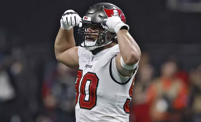 Tampa Bay Buccaneers defensive end Logan Hall (90) reacts after sacking Atlanta Falcons quarterback Kirk Cousins during the first half of an NFL football game Thursday, Oct. 3, 2024, in Atlanta. (AP Photo/Butch Dill)