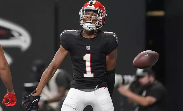 Atlanta Falcons wide receiver Darnell Mooney (1) reacts after his score against the Tampa Bay Buccaneers during the first half of an NFL football game Thursday, Oct. 3, 2024, in Atlanta. (AP Photo/John Bazemore)