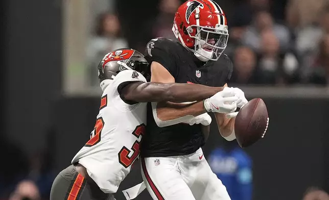 Tampa Bay Buccaneers cornerback Jamel Dean (35) breaks up a pass intended for Atlanta Falcons wide receiver Drake London (5) during the first half of an NFL football game Thursday, Oct. 3, 2024, in Atlanta. (AP Photo/John Bazemore)