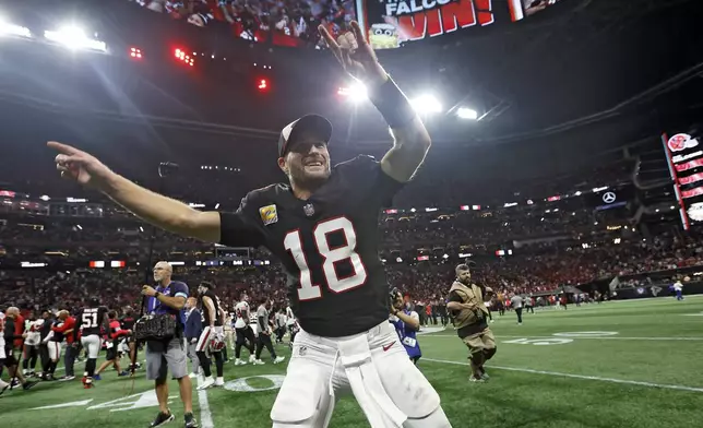 Atlanta Falcons quarterback Kirk Cousins (18) celebrates with the fans after the team defeated the Tampa Bay Buccaneers during overtime in an NFL football game Thursday, Oct. 3, 2024, in Atlanta. (AP Photo/Butch Dill)