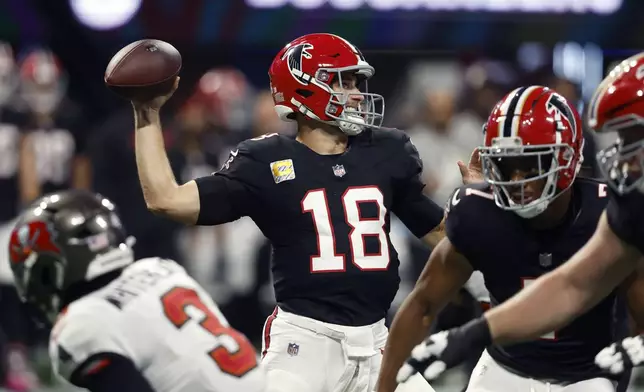 Atlanta Falcons quarterback Kirk Cousins throws a pass against the Tampa Bay Buccaneers during the first half of an NFL football game Thursday, Oct. 3, 2024, in Atlanta. (AP Photo/John Bazemore)