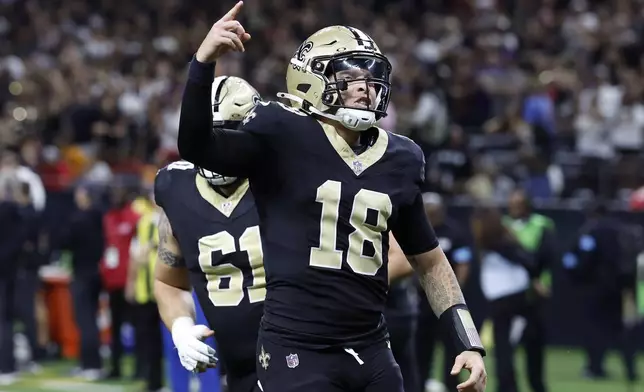 New Orleans Saints quarterback Spencer Rattler (18) celebrates during the first half of an NFL football game against the Tampa Bay Buccaneers in New Orleans, Sunday, Oct. 13, 2024. (AP Photo/Butch Dill)