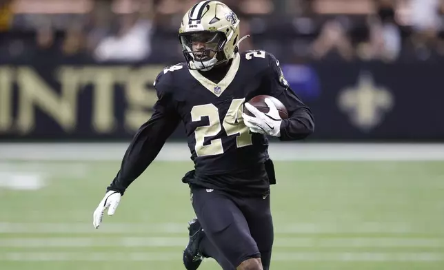 New Orleans Saints safety Johnathan Abram (24) returns an interception against the Tampa Bay Buccaneers during the first half of an NFL football game in New Orleans, Sunday, Oct. 13, 2024. (AP Photo/Butch Dill)