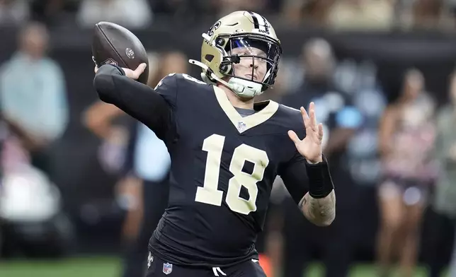 New Orleans Saints quarterback Spencer Rattler (18) passes against the Tampa Bay Buccaneers during the first half of an NFL football game in New Orleans, Sunday, Oct. 13, 2024. (AP Photo/Michael Conroy)