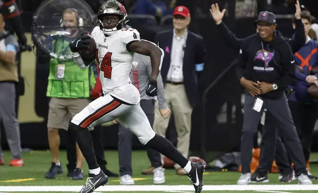 Tampa Bay Buccaneers wide receiver Chris Godwin runs toward the end zone to score against the New Orleans Saints during the second half of an NFL football game in New Orleans, Sunday, Oct. 13, 2024. (AP Photo/Butch Dill)