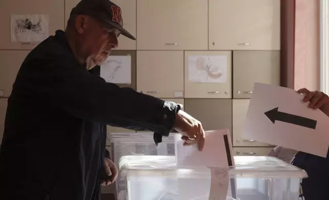 A man casts his ballot at a polling station during the general elections in Sofia, Sunday, Oct. 27, 2024. (AP Photo/Valentina Petrova)