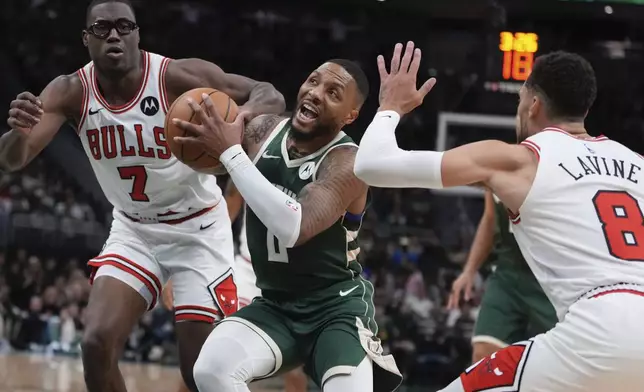 Milwaukee Bucks' Damian Lillard tries to get past Chicago Bulls' Jalen Smith and Zach LaVine during the first half of an NBA basketball game Friday, Oct. 25, 2024, in Milwaukee. (AP Photo/Morry Gash)