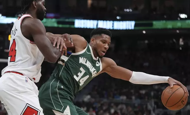 Milwaukee Bucks' Giannis Antetokounmpo tries to get past Chicago Bulls' Patrick Williams during the first half of an NBA basketball game Friday, Oct. 25, 2024, in Milwaukee. (AP Photo/Morry Gash)