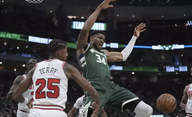 Chicago Bulls' Dalen Terry fouls Milwaukee Bucks' Giannis Antetokounmpo during the first half of an NBA basketball game Friday, Oct. 25, 2024, in Milwaukee. (AP Photo/Morry Gash)