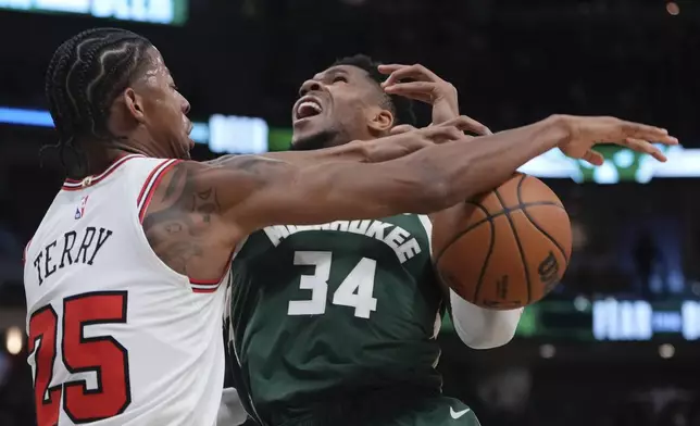 Chicago Bulls' Dalen Terry fouls Milwaukee Bucks' Giannis Antetokounmpo during the first half of an NBA basketball game Friday, Oct. 25, 2024, in Milwaukee. (AP Photo/Morry Gash)