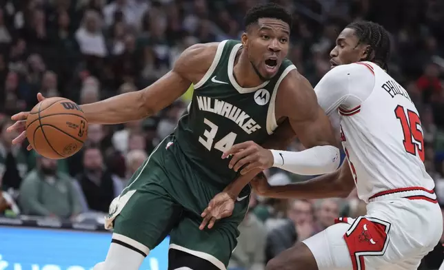 Milwaukee Bucks' Giannis Antetokounmpo tries to get past Chicago Bulls' Julian Phillips during the first half of an NBA basketball game Friday, Oct. 25, 2024, in Milwaukee. (AP Photo/Morry Gash)