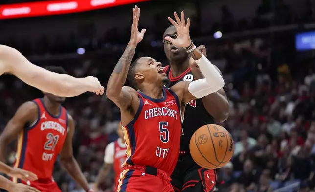 New Orleans Pelicans guard Dejounte Murray (5) loses the ball as he drives to the basket against Chicago Bulls forward Jalen Smith in the first half of an NBA basketball game in New Orleans, Wednesday, Oct. 23, 2024. (AP Photo/Gerald Herbert)