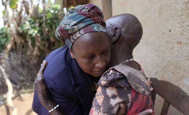 Emelyne Nzeyimana, left, and Prudencienne Namukobwa, perform akazehe, a Burundian traditional form of musical greeting performed exclusively by women, outside her home in Ngozi, Burundi, Friday, Sept. 20, 2024. (AP Photo/Brian Inganga)