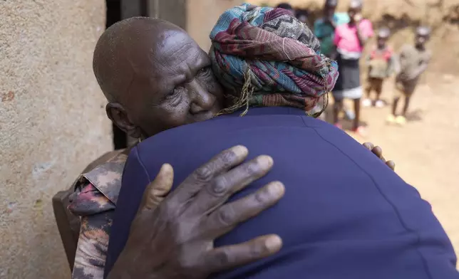 Emelyne Nzeyimana, right, and Prudencienne Namukobwa, perform akazehe, a Burundian traditional form of musical greeting performed exclusively by women, outside her home in Ngozi, Burundi, Friday, Sept. 20, 2024. (AP Photo/Brian Inganga)