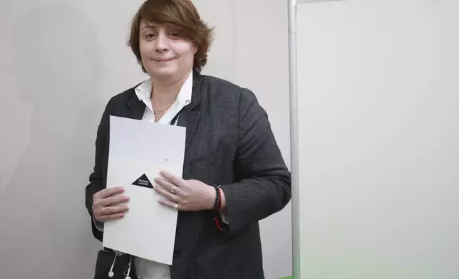 Elene Khoshtaria, the leader of the Strong Georgia Coalition, holds a ballot at a polling station during the parliamentary election in Tbilisi, Georgia, Saturday, Oct. 26, 2024. (AP Photo/Zurab Tsertsvadze)