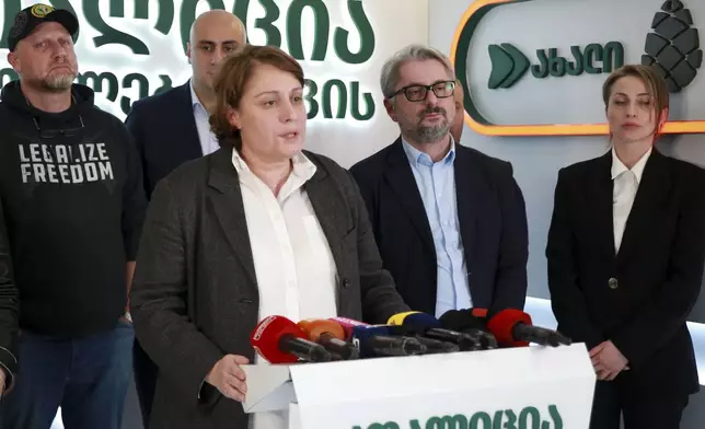 Elene Khoshtaria, the leader of the Strong Georgia Coalition, center, speaks to the media, accompanied by Zurab Japaridze, chairman of the Girchi More Freedom party, left; Nika Melia, a leader of Coalition for Changes, second left, Nika Gvaramia, leader of Coalition for Changes, second right, and Nana Malashkhia, who leads the Coalition for Change parliament list, right, at the coalition's headquarters after the parliamentary election in Tbilisi, Georgia, early Sunday, Oct. 27, 2024. (AP Photo/Zurab Tsertsvadze)