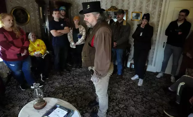 CORRECTS FIRST NAME TO RICHARD INSTEAD OF JACK - Tour guide Richard Sheridan, center, speaks to a group of visitors while touring the Lizzie Borden House, site of an 1892 double axe murder, Wednesday, Oct. 16, 2024, in Fall River, Mass. (AP Photo/Steven Senne)