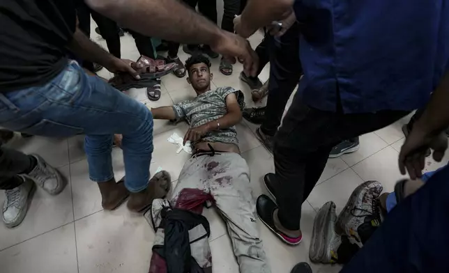 CORRECTS DATE A Palestinian wounded in the Israeli bombardment of the Gaza Strip is treated in a hospital in Deir el-Balah, Sunday, Oct. 20, 2024. (AP Photo/Abdel Kareem Hana)