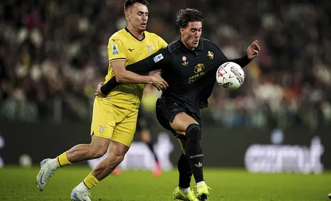 CORRECTS DAY- Lazio's Patric, left, vies for the ball with Juventus' Dusan Vlahovic during the Serie A soccer match at the Allianz Stadium in Torino, Italy, Saturday, Oct. 19, 2024. (Marco Alpozzi/LaPresse via AP)