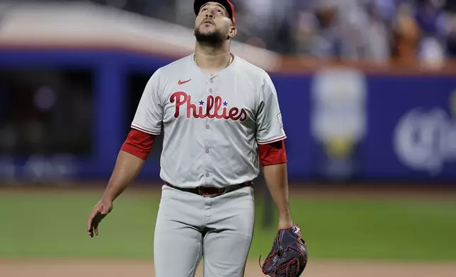 RETRANSMISSION TO CORRECT ID - Philadelphia Phillies reliever Carlos Estévez walks off the field at the end of the sixth inning after giving up a grand slam home run to the New York Mets during Game 4 of the National League baseball playoff series, Wednesday, Oct. 9, 2024, in New York. (AP Photo/Adam Hunger)