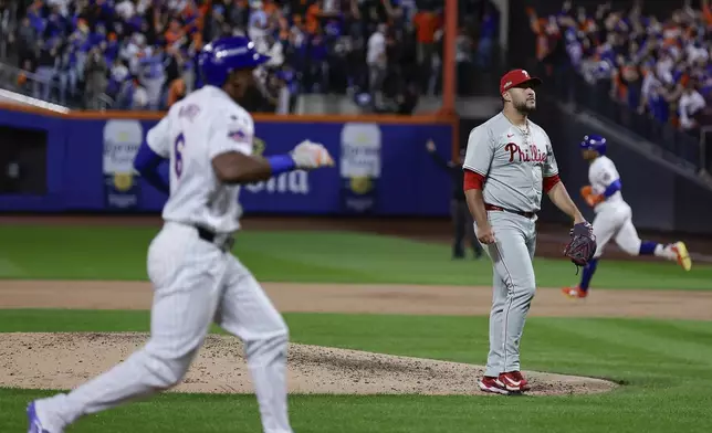 RETRANSMISSION TO CORRECT ID - Philadelphia Phillies reliever Carlos Estévez (53) reacts after giving up a grand slam home run to the New York Mets during the sixth inning of Game 4 of the National League baseball playoff series, Wednesday, Oct. 9, 2024, in New York. (AP Photo/Adam Hunger)