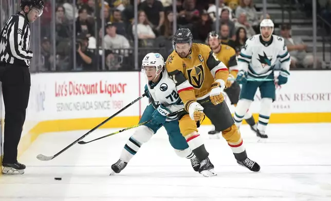 CORRECTS NAME OF SHARKS PLAYER TO WILLIAM EKLUND FROM MACKLIN CELEBRINI - San Jose Sharks left wing William Eklund (72) battles for the puck against Vegas Golden Knights right wing Mark Stone (61) during the first period of an NHL hockey game Saturday, Oct. 26, 2024, in Las Vegas. (AP Photo/Lucas Peltier)