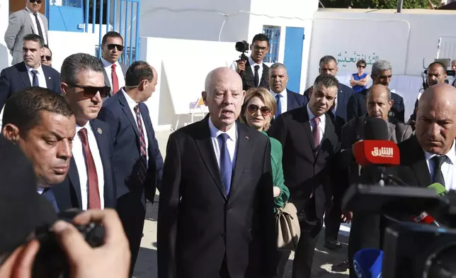 CORRECTS TO NASIR DISTRICT - Tunisian President and candidate for re-election Kais Saied and his wife Ichraf Chebil Saïed, leave a polling station after casting their votes, at Nasr district of the capital Tunis, Tunisia, Sunday, Oct. 6, 2024. (AP Photo/Anis Mili)