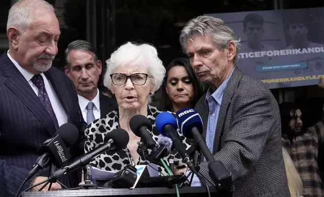 Kitty Menendez' sister, Joan Andersen VanderMolen, center, walks up to podium to make a statement during a press conference to announce developments on the case of brothers Erik and Lyle Menendez, Wednesday, Oct. 16, 2024, in Los Angeles. (AP Photo/Damian Dovarganes)