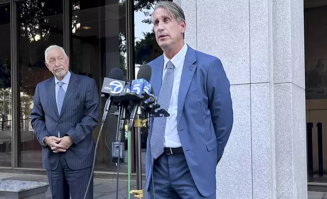 Attorneys Bryan Freedman, center, and Mark Geragos, left, address the media on developments on the case of brothers Lyle and Erik Menendez, both serving life sentences for the murder of their parents in 1989, Thursday, Oct. 3, 2024 in Los Angeles. (AP Photo/Jaimie Ding)